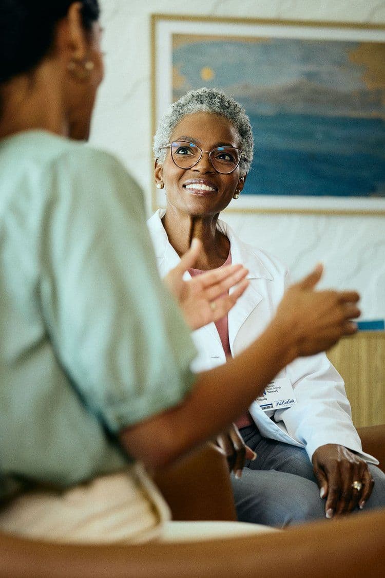 A clinician in conversation with a patient — what a real, unhurried consultation looks like.